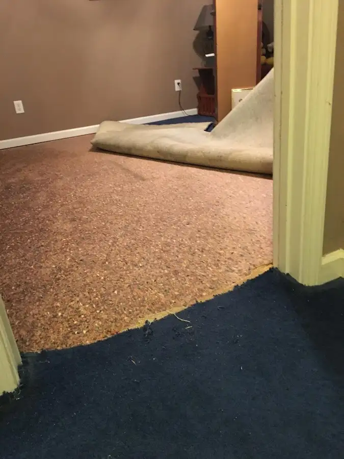 Carpet pad removal revealing water damage during Drying & Dehumidification in Morrilton